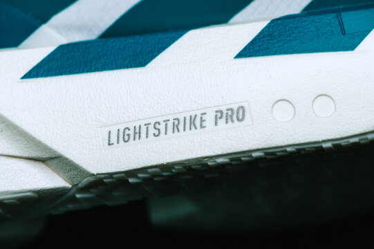 Adidas Adizero Adios Pro 4 extreme close-up of Lightstrike Pro midsole and Continental outsole, showcasing carbon racing plate technology.
