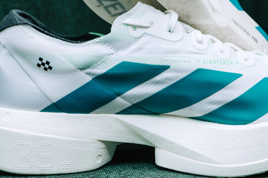 Adidas Adizero Adios Pro 4 studio macro of outsole and midsole, Lightstrike Pro foam, Continental grip pattern and carbon energy rods in focus.