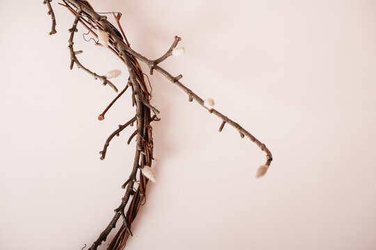 Twig wreath with pussy willow branches on wall