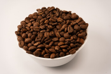 Fototapeta premium Coffee beans on a white background. Top view. Coffee beans texture.