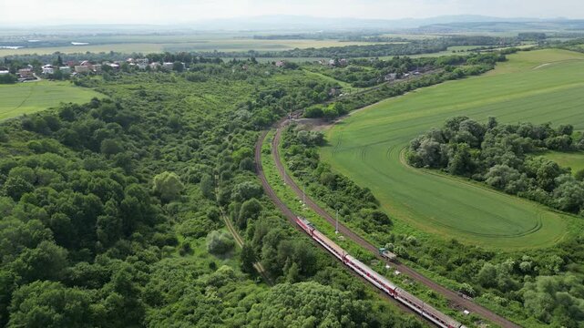 Aerial view of Train ride on rails in eastern Slovakia countryside, summer landscape, 4K