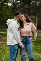 Fototapeta premium Young couple kissing enjoying romantic moment outdoors