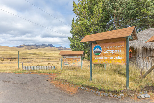 Cotopaxi Province, Ecuador - February 5, 2026: Sign at the northern entrance of Cotopaxi National Park, El Pedregal. In the background, the Rumi&ntilde;ahui volcano can be seen, partially covered by clouds.
