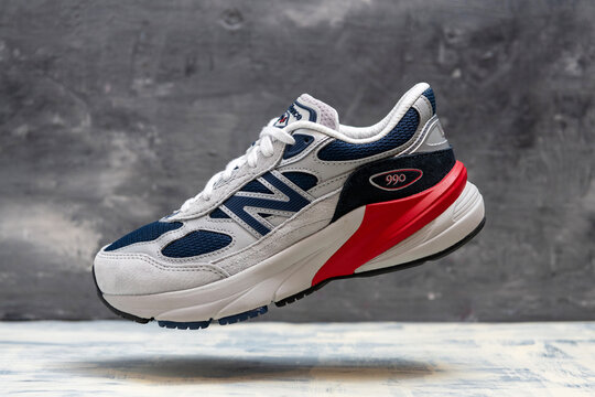 New Balance 990 athletic shoe levitation concept with red midsole and mesh