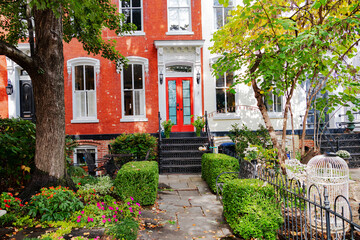 Fototapeta premium Washington DC residential street featuring red brick townhouse and fall foliage