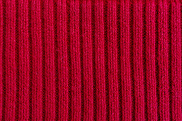 Red ribbed knitted fabric vertical pattern background © Iryna Miadzvedzeva