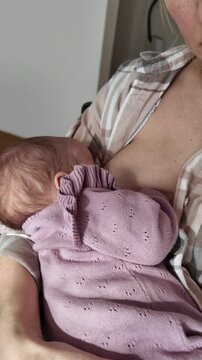 Close-up of baby breastfeeding with proper latch technique. Focus on infant mouth and mothers breast. Concept of natural feeding, newborn nutrition and maternal care.