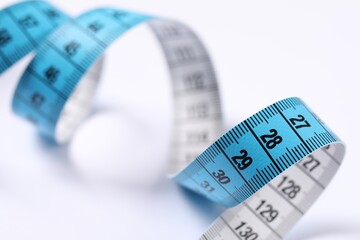 One measuring tape on white background, closeup
