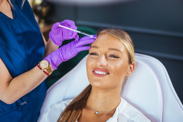 Smiling Woman Receiving Cosmetic Injection At Aesthetic Clinic During Facial Beauty Treatment And...