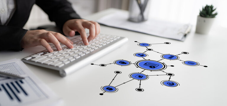 A business professional engages with digital technology symbols on a modern office desk. This image highlights innovation and connectivity in today work environment. Tessel
