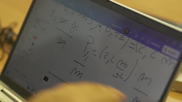 Close Up of Mathematical Equations on Laptop Screen While Teacher and Student Solve Math Problem