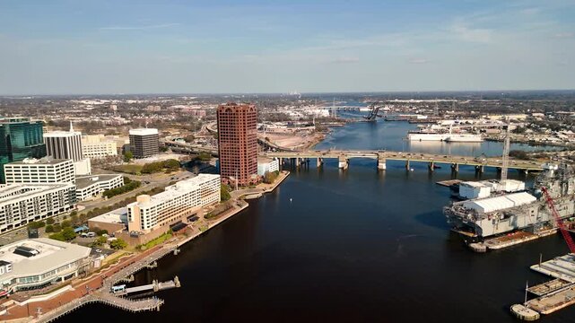 Aerial cinematic view of downtown Norfolk Virginia waterfront featuring Nauticus museum and the USS Wisconsin battleship