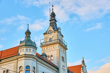 Fototapeta premium Historic clock tower against blue sky in early evening light