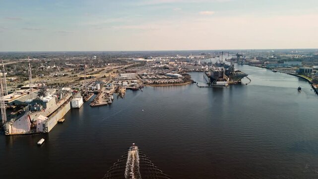 Aerial cinematic view of downtown Norfolk Virginia waterfront featuring Nauticus museum and the USS Wisconsin battleship