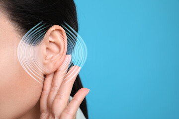 Hearing health. Woman with audio waves around her ear on blue background, closeup