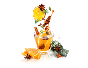 Mulled wine recipe. Spices and other ingredients falling into glass cup with beverage against white...