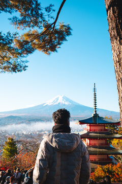 Man looking at Mount Fuji and famous Chureito Pagoda