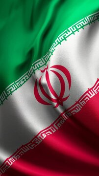 Close-up of the Iranian national flag waving in the wind.