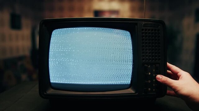 Retro TV, vintage television In a nostalgic setup, a retro TV displays grain on screen, scary halloween night device good for chroma key and green screen.