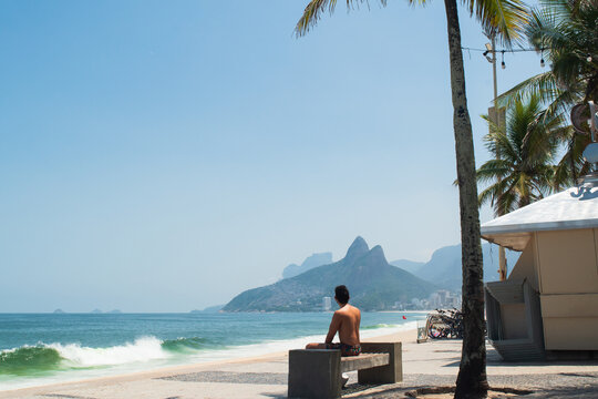 Rio de Janeiro and tourist at Ipanema coastline with bicycles and beach scenery