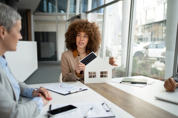 Woman presenting solar energy solutions for sustainable home