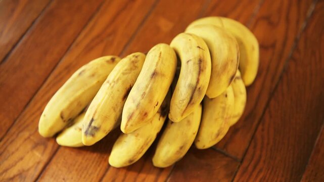 Manzano banana manzanos bananas bunch heap stack group, yellow ripe fruit macro closeup at home kitchen