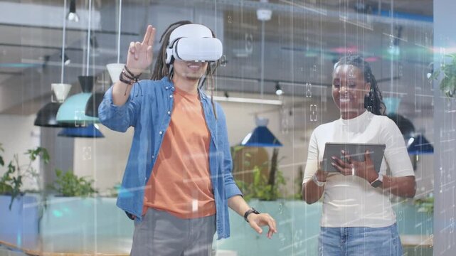 VR tester wearing headset reaching and activating holo HUD in tech demo while woman using tablet
