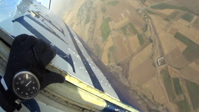 Man jumps out of a plane with a parachute. Point of View. 