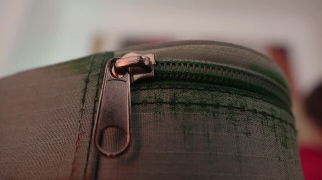 Macro Close Up of Green Canvas Pencil Case With Metal Zipper Highlighting Fabric Texture, Stitching Detail and Everyday School Organization