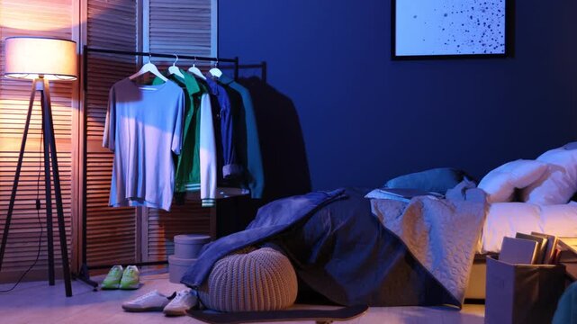 Stylish teenager's room with comfortable bed, clothes and skateboard, camera moving in. Interior design
