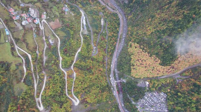Drone view of Yangrong Hade, or Yangrong Village, well-preserved Jiarong Tibetan village in Aba, Sichuan, China. Colorful autumn forest in rainy day. 4k real time footage b roll shot travel concept
