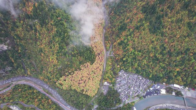 Drone view of Yangrong Hade, or Yangrong Village, well-preserved Jiarong Tibetan village in Aba, Sichuan, China. Colorful autumn forest in rainy day. 4k real time footage b roll shot travel concept