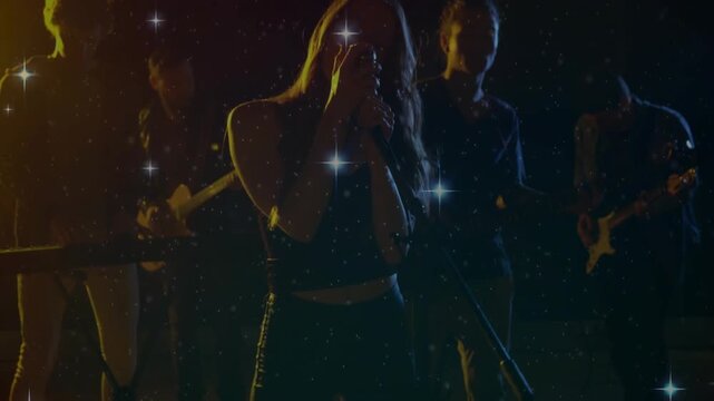 Camera rising lead singer moving center, singing music into mic, band playing under star overlay