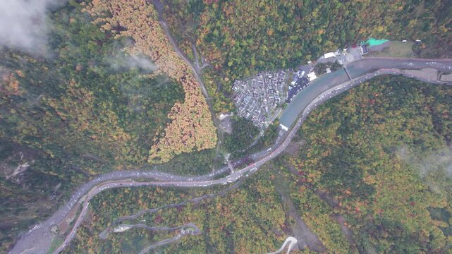 Drone view of Yangrong Hade, or Yangrong Village, well-preserved Jiarong Tibetan village in Aba, Sichuan, China. Colorful autumn forest in rainy day. 4k real time footage b roll shot travel concept