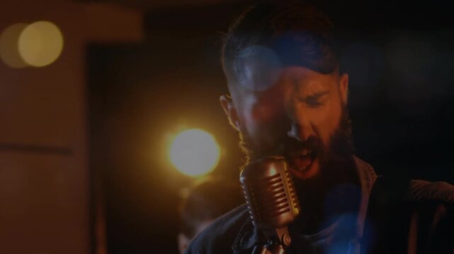 Drummer starting, camera moving from guitar to lead singer singing, ending on backup singer music