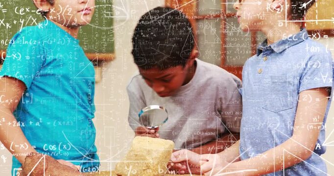 Three boys leaning over table, center lifting magnifier, examining yellow fossil for museum study