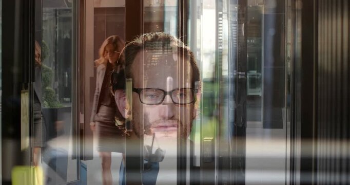 Face-overlaid man raising card, checking ID, adjusting glasses while traveler passing through lobby