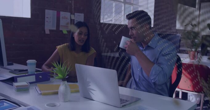 Business colleagues reviewing laptop after woman pointing binder, man sipping mug, overlay passing