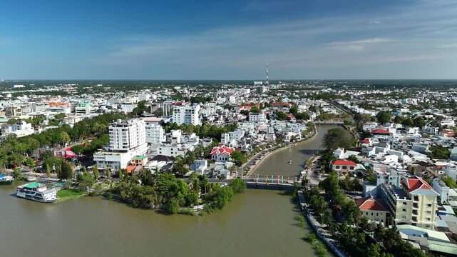 Vinh Long City, Vietnam &ndash; 4K aerial drone footage of Mekong Delta riverfront cityscape, towers, dense houses, bridges, boats and canals in southern Vietnam