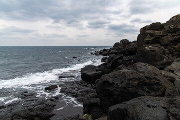 idyllic seascape at the seaside of Seopjikoji in Jeju Island, South Korea, on overcast day