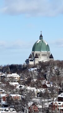 Saint Josephs Oratory dome above snowy Westmount and Montreal neighborhood on Mount Royal hill in winter, Quebec, Canada. g.