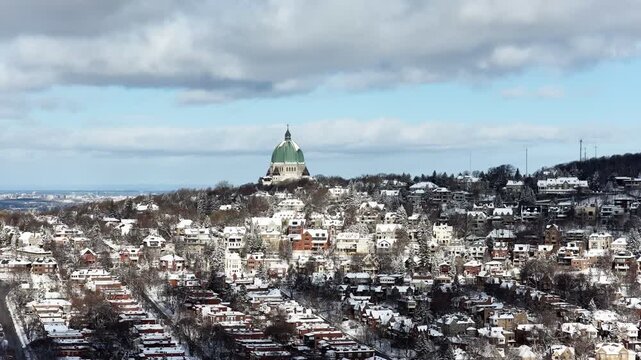 Saint Josephs Oratory dome above snowy Westmount and Montreal neighborhood on Mount Royal hill in winter, Quebec, Canada. g.
