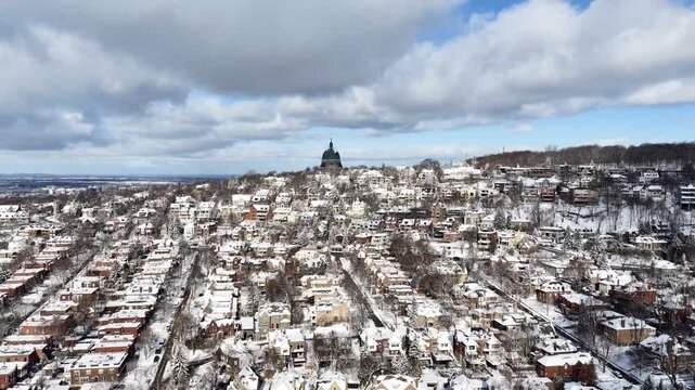 Saint Josephs Oratory dome above snowy Westmount and Montreal neighborhood on Mount Royal hill in winter, Quebec, Canada. g.