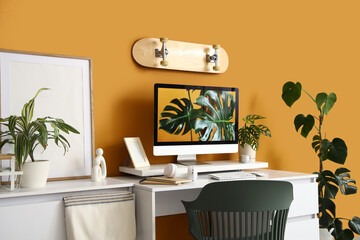 Interior of stylish office with workplace, plants and skateboard © Pixel-Shot