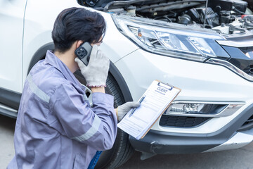 Obraz premium Auto repair shop, small business owner, garage, technology mechanic photographing wheel damage for inspection, customer consultation, quotation online service estimate, insurance claim agent support.