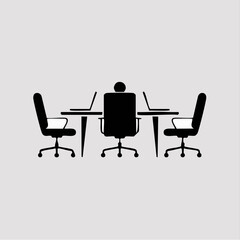 Fototapeta premium Silhouette of a person sitting at a conference table with laptops.