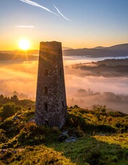 A serene landscape with a stone tower at sunrise