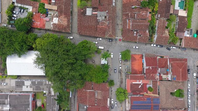 Paraty Historic Center colonial urban grid with terracotta rooftops and tree-filled pra&ccedil;a near Ba&iacute;a de Paraty coastline in Rio de Janeiro Brazil preserved Portuguese planning structure, top down aeria