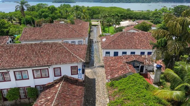 Historic Portuguese colonial architecture along stone paved street in Centro Hist&oacute;rico de Paraty, Paraty municipality, Rio de Janeiro state Brazil showing preserved urban layout near Ba&iacute;a coastline