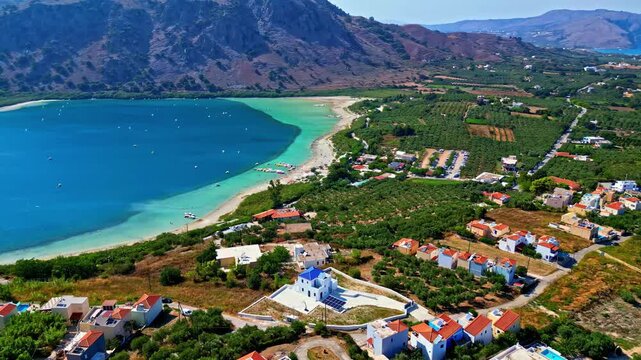 High panoramic aerial view over Lake Kournas with the village and the surrounding mountains.